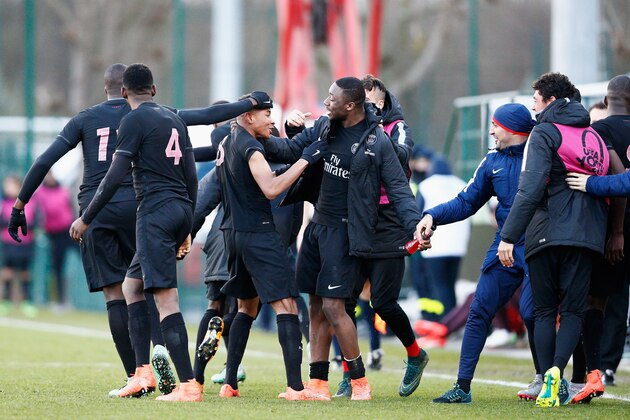 POISSY, FRANCE - MARCH 09:  Christopher Nkunku #8 of PSG celebrates with team mates after he scores his teams third goal during the UEFA Youth League Quarter-final match between Paris Saint Germain and AS Roma at Stade Georges-Lefevre on March 9, 2016 in Poissy, France.  (Photo by Dean Mouhtaropoulos/Getty Images)