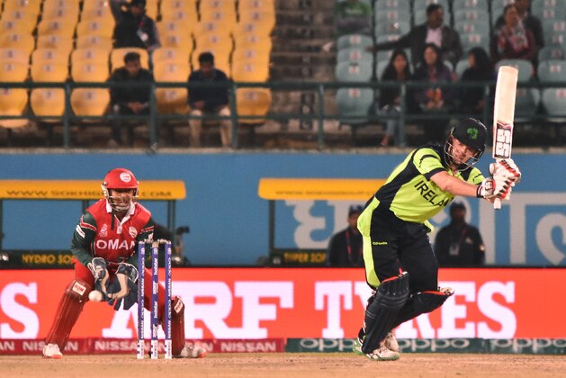 Ireland's William Porterfield(R)is watched by Oman's captain and wicketkeeper Sultan Ahmed as he plays a shot during the World T20 cricket tournament match between Ireland and Oman at The Himachal Pradesh Cricket Association Stadium in Dharamsala on March 9, 2016.  / AFP / STRINGER        (Photo credit should read STRINGER/AFP/Getty Images)