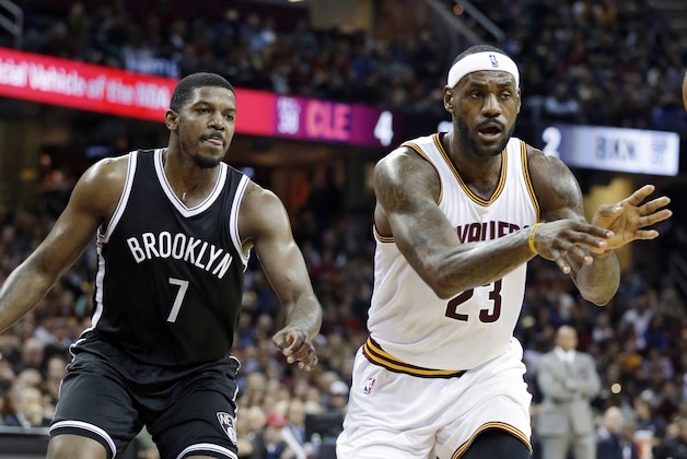 Cleveland Cavaliers' LeBron James (23) passes in front of Brooklyn Nets’ Joe Johnson (7) in the first half of an NBA basketball game Saturday, Nov. 28, 2015, in Cleveland. (AP Photo/Tony Dejak)