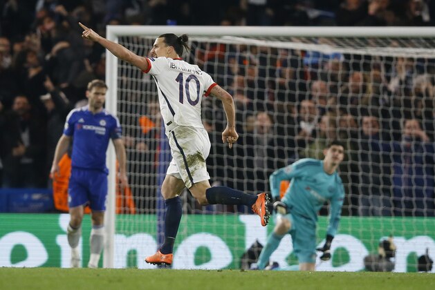 PSG's Zlatan Ibrahimovic celebrates scores his side’s second goal after passing Chelsea goalkeeper Thibaut Courtois, right, during the round of sixteen second leg Champions League soccer match between Chelsea and Paris Saint-Germain at Stamford Bridge stadium in London, Wednesday, March 9, 2016. (AP Photo/Kirsty Wigglesworth)