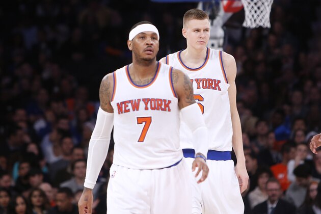 From left, New York Knicks' Carmelo Anthony (7), Kristaps Porzingis, of Latvia, and Arron Afflalo (4) walk up the court during the second quarter of an NBA basketball game against the Chicago Bulls Saturday, Dec. 19, 2015, in New York.  New York defeated Chicago 107-91. (AP Photo/Jason DeCrow)