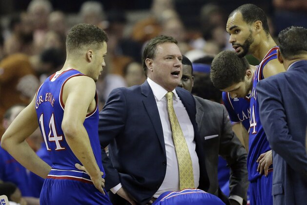 Kansas head coach Bill Self, center, talks to his players during the first half of an NCAA college basketball game against Texas, Monday, Feb. 29, 2016, in Austin, Texas. (AP Photo/Eric Gay)