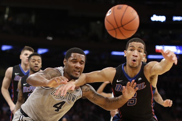 Georgetown guard D'Vauntes Smith-Rivera (4) and DePaul guard Billy Garrett Jr. (5) chase after the ball during the first half of an NCAA college basketball game during the Big East men's tournament Wednesday, March 9, 2016, in New York. (AP Photo/Julie Jacobson)
