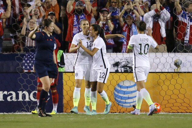 United States' Alex Morgan (13) is congratulated by Christen Press (12) after scoring a goal against Germany during the first half of a soccer game in the SheBelieves Cup, Wednesday, March 9, 2016,  in Boca Raton, Fla.  (AP Photo/Joel Auerbach)