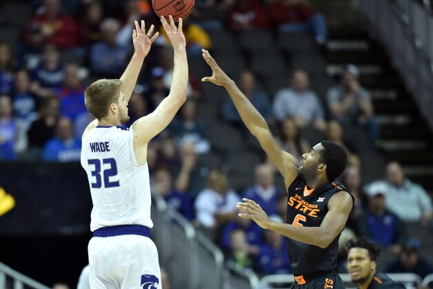 Mar 9, 2016; Kansas City, MO, USA; Kansas State Wildcats forward Dean Wade (32) shoots the ball as Oklahoma State Cowboys guard Tavarius Shine (5) defends during the Big 12 Conference tournament at Sprint Center. Mandatory Credit: Denny Medley-USA TODAY Sports