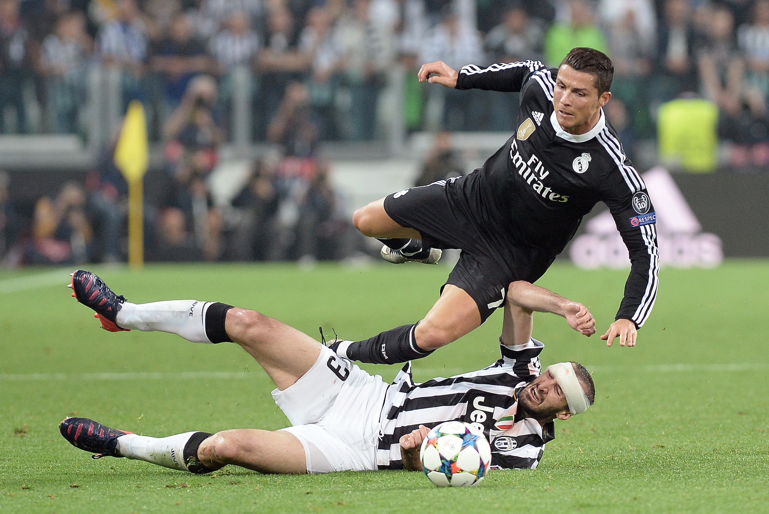 Real Madrid Cristiano Ronaldo is tackled by Juventus' Giorgio Chiellini during the Champions League, semifinal soccer match between Juventus and Real Madrid at the Juventus Stadium in Turin, Italy, Tuesday, May 5, 2015. (AP Photo/Massimo Pinca)