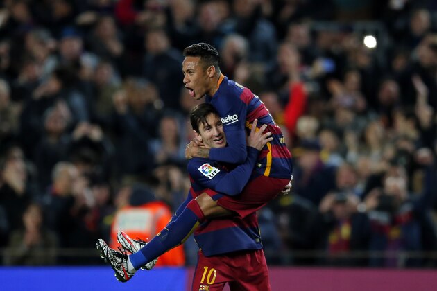 FC Barcelona's Lionel Messi, left, celebrates after scoring against Sevilla with his teammate Neymar during a Spanish La Liga soccer match at the Camp Nou stadium in Barcelona, Spain, Sunday, Feb. 28, 2016. (AP Photo/Manu Fernandez)
