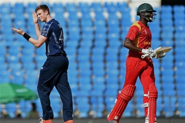 Scotland bowler Alasdair Evans, left,  celebrates the wicket of  Zimbabwe batsman Vusi Sibanda during the ICC World Twenty20 2016 cricket tournament  at the Vidarbha Cricket Association Stadium in Nagpur, India, Thursday, March 10, 2016. (Shashank Parade/Press Trust of India via AP)