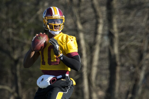FILE - In this Jan. 6, 2016 file photo, Washington Redskins quarterback Robert Griffin III eyes the receiver during NFL football practice at Redskins Park in Ashburn, Va. Griffin has cleared out his locker at Redskins Park and is expected to be let go by the team that dealt a trove of draft picks for the right to pick him No. 2 overall in  2012. (AP Photo/Manuel Balce Ceneta, File)