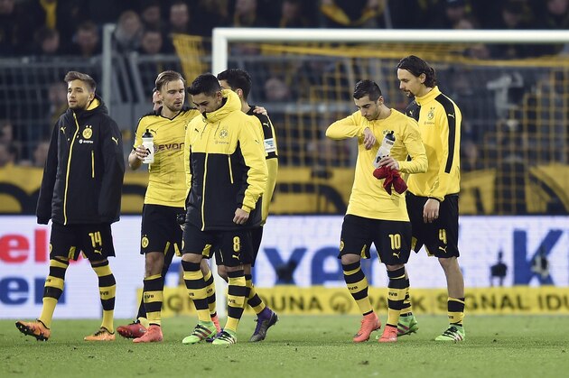 Dortmund's team leave the pitch disappointed  after the German Bundesliga soccer match between Borussia Dortmund and Bayern Munich, in Dortmund, Germany, Saturday, March 5, 2016. The match ended 0-0. (AP Photo/Martin Meissner)