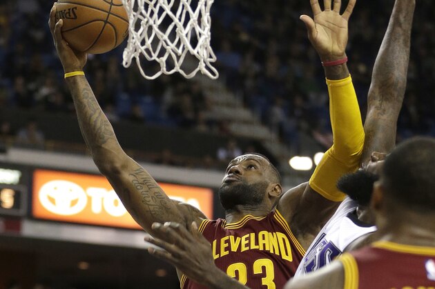 Cleveland Cavaliers forward LeBron James, left, drives to the basket against Sacramento Kings forward Quincy Acy, center, as Cavaliers center Tristan Thompson, right, looks on during the first quarter of an NBA basketball game Wednesday, March 9, 2016, in Sacramento, Calif. (AP Photo/Rich Pedroncelli)
