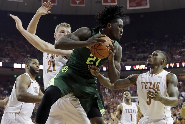 Baylor forward Taurean Prince (21) grabs a rebound in front of Texas forward Connor Lammert (21) and guard Kendal Yancy (5) during the second half of an NCAA college basketball game, Saturday, Feb. 20, 2016, in Austin, Texas. Baylor won 78-64.  (AP Photo/Eric Gay)