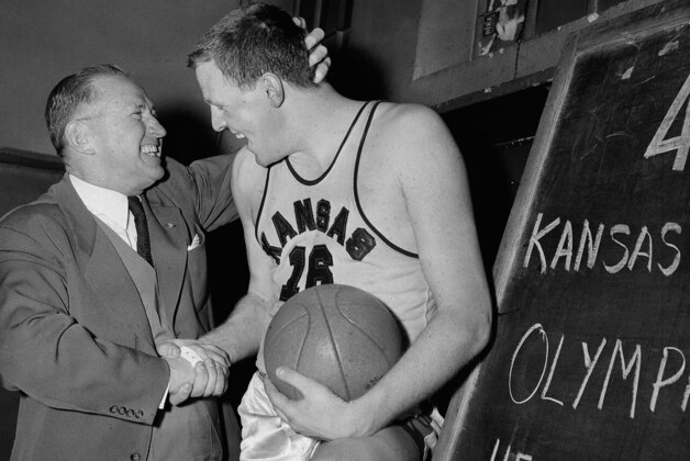 Kansas Coach Forrest Allen, left, congratulates his giant center Clyde Lovellette who led Jayhawkers with 40 points to a 70-65 victory over Lasalle in the semifinals of Olympic Basketball trials at Madison Square Garden, March 31, 1952, New York. (AP Photo/Matty Zimmerman)