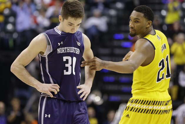 Northwestern's Bryant McIntosh (30) looks down as Michigan's Zak Irvin (21) talks to him after an NCAA college basketball game at the Big Ten Conference tournament, Thursday, March 10, 2016, in Indianapolis. Michigan won 72-70. (AP Photo/Michael Conroy)