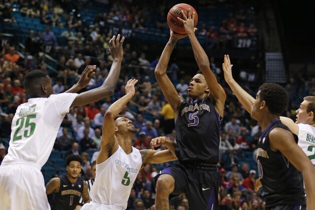 Washington guard Dejounte Murray shoots over Oregon forward Chris Boucher, left, and Oregon guard Tyler Dorsey, second from left, during the first half of an NCAA college basketball game in the quarterfinal round of the Pac-12 men's tournament Thursday, March 10, 2016, in Las Vegas. (AP Photo/John Locher)