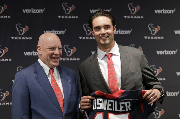 Houston Texans quarterback Brock Osweiler, right, holds his new jersey as he poses with owner Bob McNair during a news conference Thursday, March 10, 2016, in Houston. The Texans have filled their biggest need, starting free agency with a splash by snagging Osweiler from Denver. (AP Photo/David J. Phillip)