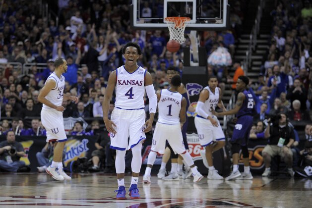 KANSAS CITY, MO - MARCH 10:  Devonte' Graham #4 of the Kansas Jayhawks celebrates a shot against the Kansas State Wildcats in the first half during the quarterfinals of the Big 12 Basketball Tournament at Sprint Center on March 10, 2016 in Kansas City, Missouri.  (Photo by Ed Zurga/Getty Images)