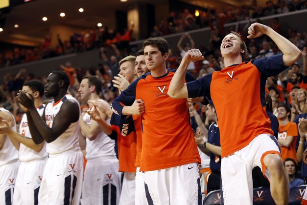 Mar 5, 2016; Charlottesville, VA, USA; Virginia Cavaliers players celebrate on the bench against the Louisville Cardinals in the second half at John Paul Jones Arena. The Cavaliers won 68-46. Mandatory Credit: Geoff Burke-USA TODAY Sports