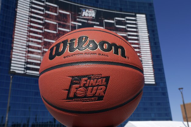 The official Wilson game ball that will be used for the for the NCAA Final Four college basketball games beginning April 4, is shown in front of a giant tournament bracket on the side of the JW Marriott Hotel in Indianapolis, Monday, March 30, 2015. (AP Photo/Michael Conroy)