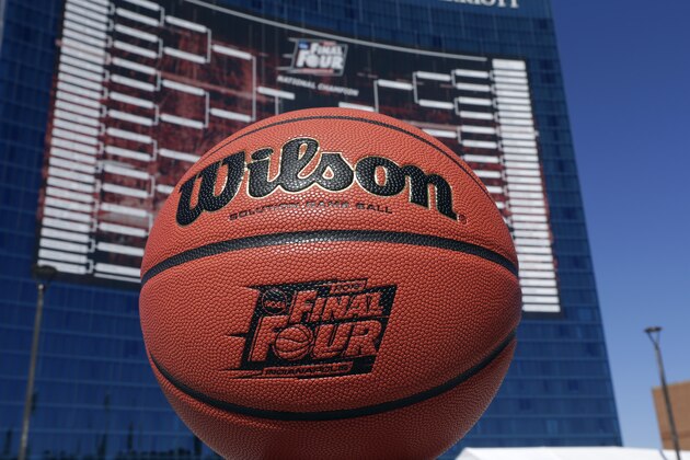 The official Wilson game ball that will be used for the for the NCAA Final Four college basketball games beginning April 4, is shown in front of a giant tournament bracket on the side of the JW Marriott Hotel in Indianapolis, Monday, March 30, 2015. (AP Photo/Michael Conroy)
