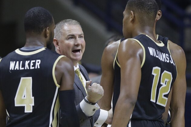 Central Florida’s head coach Donnie Jones, center, speaks with Daiquan Walker (4) and Matt Williams (12) in the first half of an NCAA college basketball game Sunday, March 6, 2016, in Storrs, Conn.  Connecticut won 67-46. (AP Photo/Steven Senne)