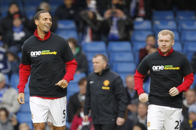 Manchester United's English defender Rio Ferdinand (L) warms up with English midfielder Paul Scholes (R), both wearing the T-shirt from Kick It Out's 'One Game, One Community' campaign before the English Premier League football match between Chelsea and Manchester United at Stamford Bridge in London, on October 28, 2012. AFP PHOTO/IAN KINGTON

RESTRICTED TO EDITORIAL USE. No use with unauthorized audio, video, data, fixture lists, club/league logos or “live” services. Online in-match use limited to 45 images, no video emulation. No use in betting, games or single club/league/player publications.        (Photo credit should read IAN KINGTON/AFP/Getty Images)