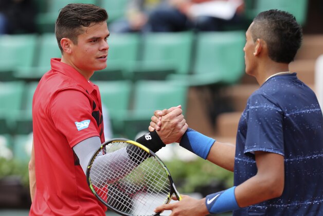 Canada's Milos Raonic, left, shakes hands with Australia's Nick Kyrgios after their first round match of  the French Open tennis tournament at the Roland Garros stadium, in Paris, France, Sunday, May 25, 2014. (AP Photo/David Vincent)