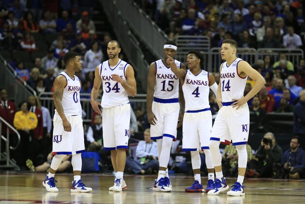 Kansas guard Frank Mason III (0), forward Perry Ellis (34), forward Carlton Bragg Jr. (15), guard Devonte' Graham (4) and guard Brannen Greene (14) during the first half of an NCAA college basketball game against Kansas State in the quarterfinals of the Big 12 conference tournament in Kansas City, Mo., Thursday, March 10, 2016. (AP Photo/Orlin Wagner)