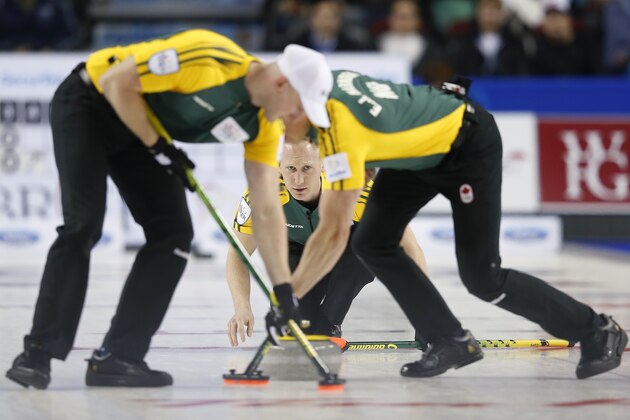 CALGARY, AB - MARCH 8: Northern Ontario skip Brad Jacobs (C) watches his shot while his teammates lead Ryan Harnden (L) and second E.J. Harnden sweep his rock in their gold medal game in curling against Team Canada during the Tim Horton's Brier at the Scotiabank Saddledome on March 8, 2015 in Calgary, Alberta, Canada. (Photo by Todd Korol/Getty Images) CALGARY, AB - MARCH 8: Northern Ontario skip Brad Jacobs (C) watches his shot while his teammates lead Ryan Harnden (L) and second E.J. Harnden sweep his rock in their gold medal game in curling against Team Canada during the Tim Horton's Brier at the Scotiabank Saddledome on March 8, 2015 in Calgary, Alberta, Canada. (Photo by Todd Korol/Getty Images)