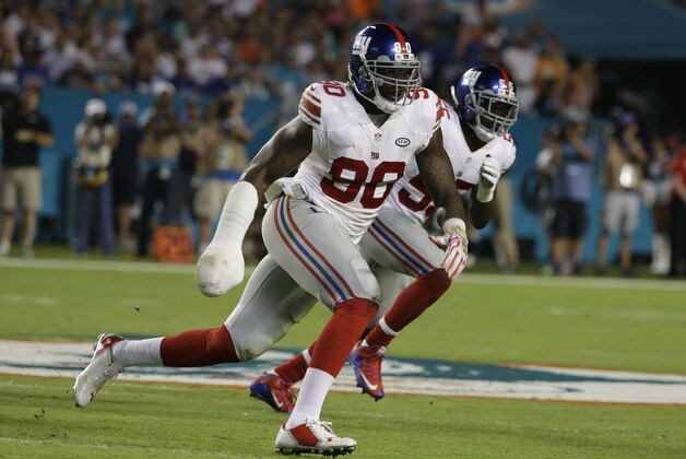 New York Giants defensive end Jason Pierre-Paul (90) runs during the first half of an NFL football game against the Miami Dolphins, Monday, Dec. 14, 2015, in Miami Gardens, Fla.  (AP Photo/Lynne Sladky)