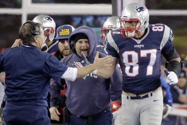 New England Patriots head coach Bill Belichick congratulates tight end Rob Gronkowski (87) after his touchdown catch against the Kansas City Chiefs in the second half of an NFL divisional playoff football game, Saturday, Jan. 16, 2016, in Foxborough, Mass. (AP Photo/Elise Amendola)