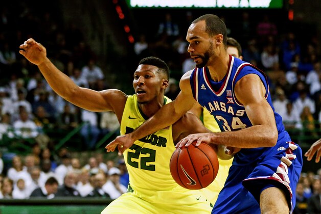 Feb 23, 2016; Waco, TX, USA; Kansas Jayhawks forward Perry Ellis (34) dribbles as Baylor Bears guard King McClure (22) defends during the first half at Ferrell Center. Mandatory Credit: Kevin Jairaj-USA TODAY Sports
