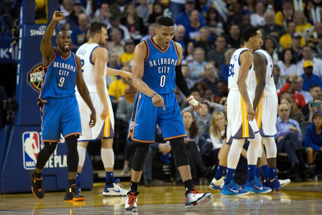 Mar 3, 2016; Oakland, CA, USA; Oklahoma City Thunder guard Russell Westbrook (0) celebrates ahead of forward Serge Ibaka (9) after a basket against the Golden State Warriors during the fourth quarter at Oracle Arena. The Golden State Warriors defeated the Oklahoma City Thunder 121-106. Mandatory Credit: Kelley L Cox-USA TODAY Sports