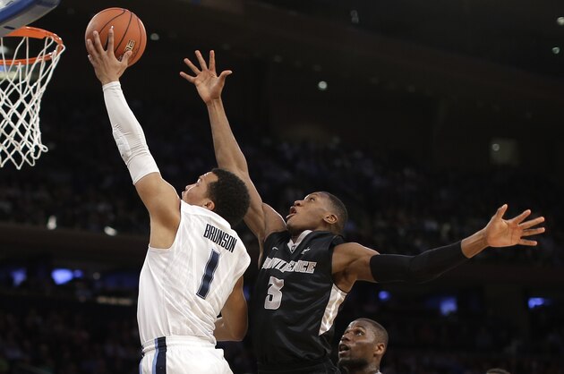Villanova guard Jalen Brunson (1) goes up to shoot against Providence guard Kris Dunn (3) in the first half of an NCAA college basketball game during the semifinals of the Big East men's tournament, Friday, March 11, 2016, in New York. (AP Photo/Julie Jacobson)