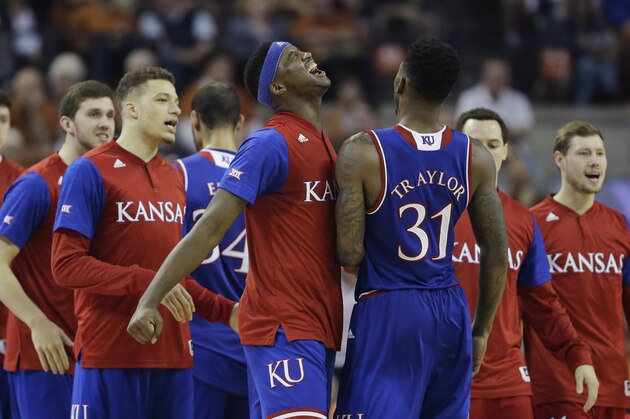 Kansas forward Carlton Bragg Jr., center, celebrates with teammate Kansas forward Jamari Traylor (31) as he walks off the court during the second half of an NCAA college basketball game against Texas, Monday, Feb. 29, 2016, in Austin, Texas. Kansas won 86-56. (AP Photo/Eric Gay)