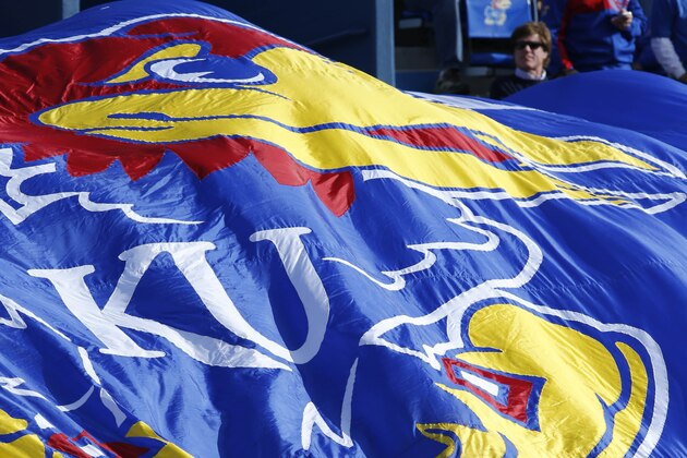 Kansas fans wave a banner during the second half of an NCAA college football game against West Virginia at Kansas Memorial Stadium in Lawrence, Kan., Saturday, Nov. 16, 2013. Kansas defeated West Virginia 31-19. (AP Photo/Orlin Wagner)