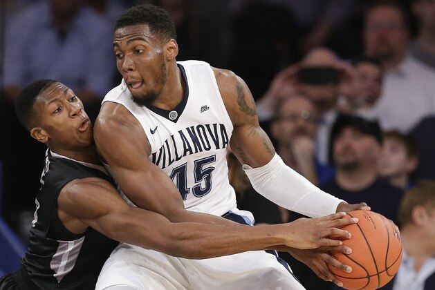 Providence guard Kris Dunn, left, tries to strip the ball from Villanova forward Darryl Reynolds (45) in the second half of an NCAA college basketball game during the semifinals of the Big East men's tournament, Friday, March 11, 2016, in New York. Villanova won 76-68. (AP Photo/Julie Jacobson)