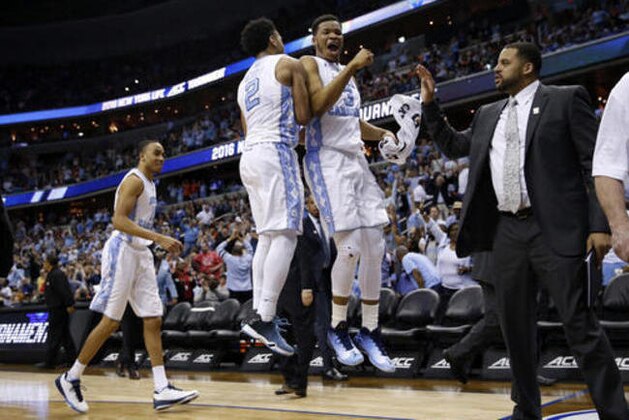 North Carolina guard Joel Berry II (2) and forward Kennedy Meeks (3) celebrate at the end of the first half of an NCAA college basketball game against Notre Dame in the Atlantic Coast Conference men's tournament, Friday, March 11, 2016, in Washington. (AP Photo/Alex Brandon)
