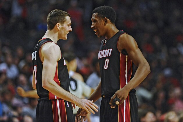 Miami Heat guard Goran Dragic, left,  and Miami Heat guard Josh Richardson celebrate in the second half of their game against the Chicago Bulls during an NBA basketball game Friday, March 11, 2016, in Chicago. The Miami Heat beat the Chicago Bulls 118-96. (AP Photo/Matt Marton)