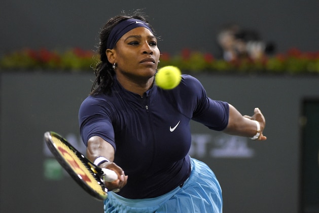 Serena Williams, of the United States, returns a shot to Laura Siegemund, of Germany, at the BNP Paribas Open tennis tournament, Friday, March 11, 2016, in Indian Wells, Calif. (AP Photo/Mark J. Terrill)