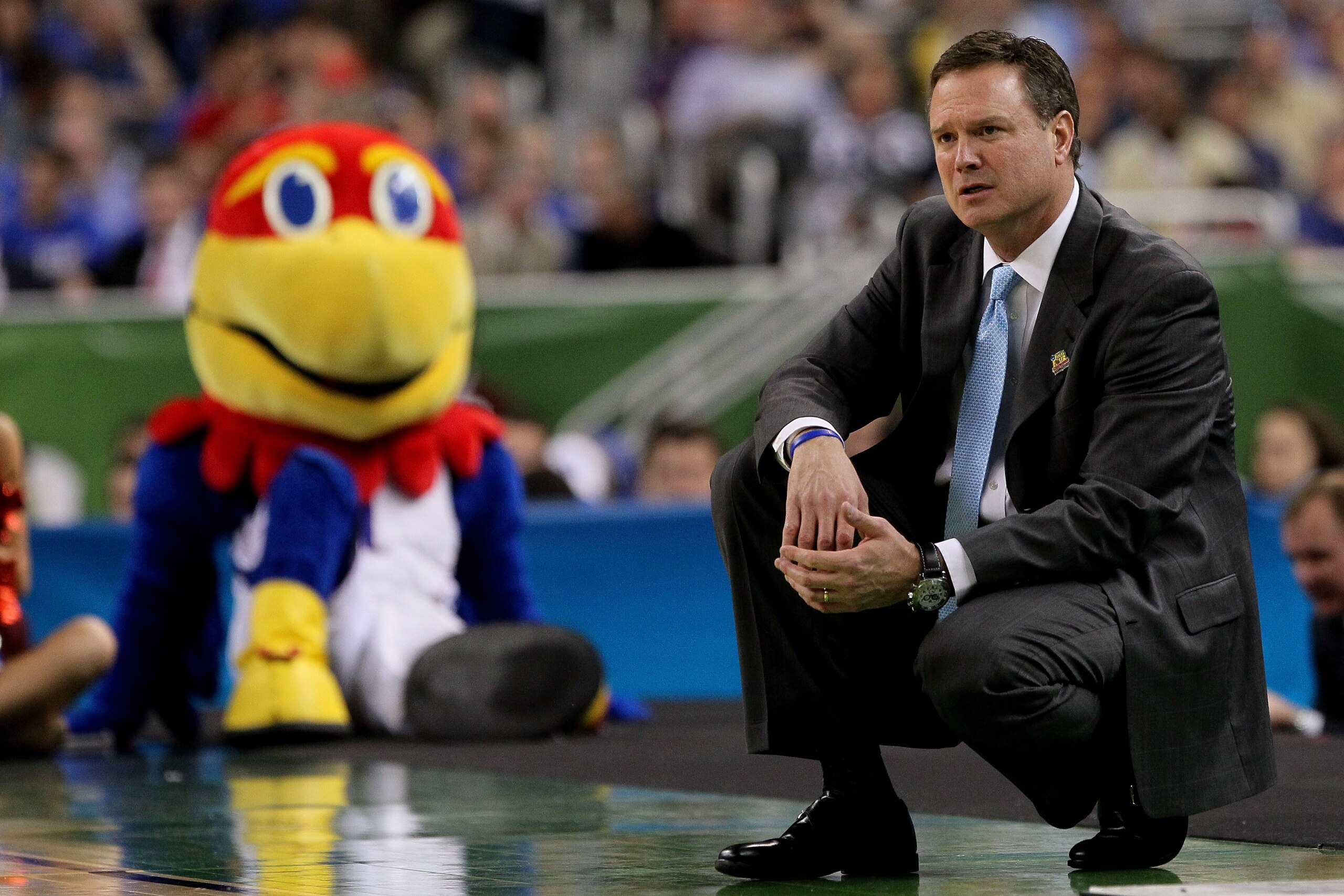 NEW ORLEANS, LA - MARCH 31:  Head coach Bill Self of the Kansas Jayhawks reacts in the first half as the Jayhawks mascot looks over at him as the Jayhawks take on the Ohio State Buckeyes during the National Semifinal game of the 2012 NCAA Division I Men's Basketball Championship at the Mercedes-Benz Superdome on March 31, 2012 in New Orleans, Louisiana.  (Photo by Chris Graythen/Getty Images)