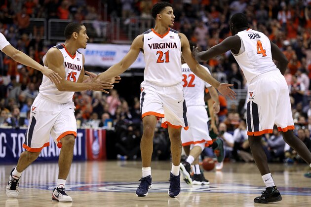 WASHINGTON, DC - MARCH 11: Isaiah Wilkins #21 celebrates with teammates Malcolm Brogdon #15 and Marial Shayok #4 of the Virginia Cavaliers against the Miami (Fl) Hurricanes during the second half in the semifinals of the 2016 ACC Basketball Tournament at Verizon Center on March 11, 2016 in Washington, DC. The Virginia Cavaliers won, 73-68.(Photo by Patrick Smith/Getty Images)