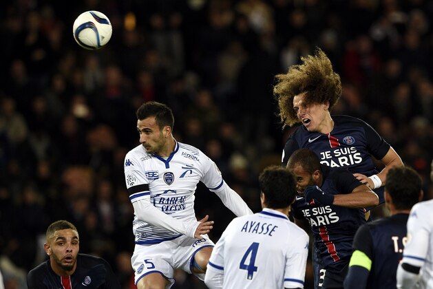 Troyes' French defender Matthieu Saunier (L) and Paris Saint-Germain's Brazilian defender David Luiz (R) jump to head the ball during the French L1 football match between Paris Saint-Germain (PSG) and Troyes at the Parc des Princes stadium in Paris on November 28, 2015. AFP PHOTO / FRANCK FIFE / AFP / FRANCK FIFE        (Photo credit should read FRANCK FIFE/AFP/Getty Images)