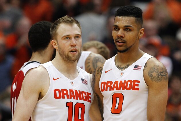 Syracuse’s Trevor Cooney, left, and Michael Gbinije, right, gather late in the second half of an NCAA college basketball game against North Carolina in Syracuse, N.Y., Saturday, Feb. 27, 2016. Syracuse won 75-66. (AP Photo/Nick Lisi)