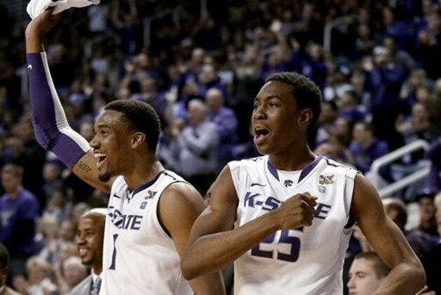 FILE - In this Dec. 31, 2013 file photo, Kansas State's Shane Southwell (1) and Wesley Iwundu (25) celebrate a teammate's basket during the first half of an NCAA college basketball game against George Washington, in Manhattan, Kan. Three teams from Kansas are ranked. Maybe it's time to forget about Tobacco Road for a moment and look toward the Sunflower State. (AP Photo/Charlie Riedel, File)