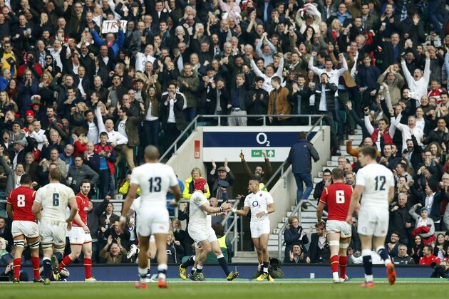 England’s Anthony Watson, centre right, celebrates scoring a try during the Six Nations international rugby match between England and Wales at Twickenham stadium in London, Saturday, March,12, 2016. (AP Photo/Alastair Grant)