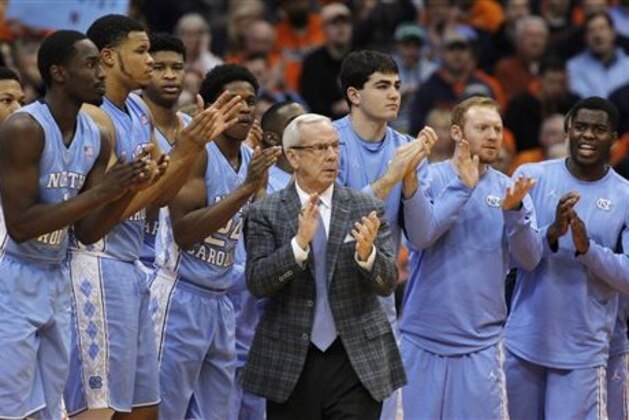 FILE - In this Jan. 9, 2016, file photo, North Carolina head coach Roy Williams claps with players on the bench during the second half of an NCAA college basketball game against Syracuse in Syracuse, N.Y. No. 2 North Carolina is the only unbeaten team in the Atlantic Coast Conference after a favorable opening month of the league schedule. The Tar Heels on Saturday play Boston College, which is 0-7 in the league. Then things get tougher.  (AP Photo/Nick Lisi, File)