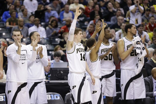 The Purdue bench reacts to a 3-point basket against Michigan in the second half of an NCAA college basketball game during the semifinals of the Big Ten Conference tournament in Indianapolis, Saturday, March 12, 2016. (AP Photo/Michael Conroy)