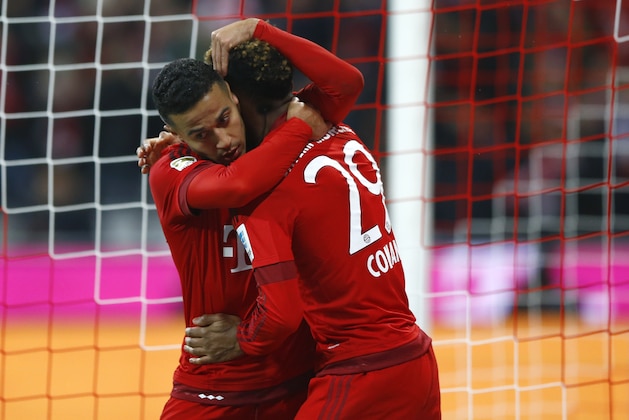 Bayern's Thiago, left, hugs teammate Kingsley Coman after scoring his side's fifth goal during the German Bundesliga soccer match between FC Bayern Munich and SV Werder Bremen at the Allianz Arena stadium in Munich, Germany, Saturday, March 12, 2016. (AP Photo/Matthias Schrader)
