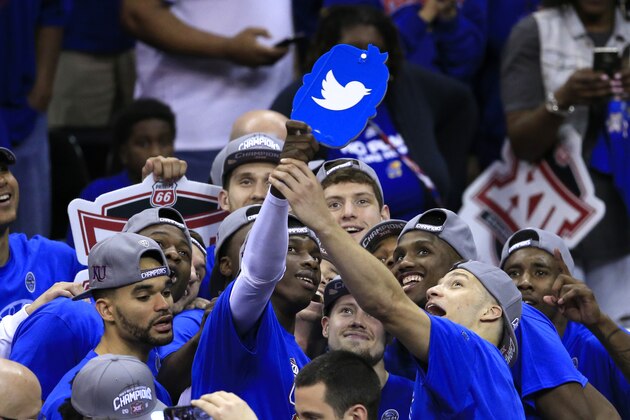 The Kansas Jayhawks pose for a team photo after winning an NCAA college basketball game against West Virginia in the finals of the Big 12 conference tournament in Kansas City, Mo., Saturday, March 12, 2016. (AP Photo/Orlin Wagner)